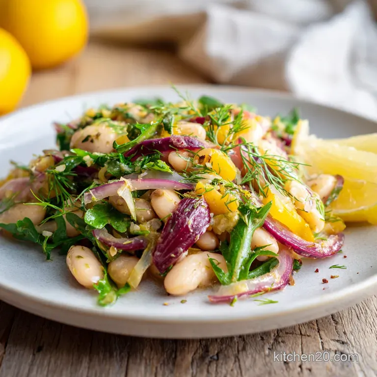 Glossy white beans and vibrant vegetables artfully arranged on a plate, drizzled with a bright, emulsified vinaigrette.