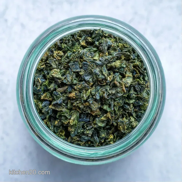 Small piles of dried green herbs on a rustic wooden board next to a small ceramic pinch bowl and a linen cloth.